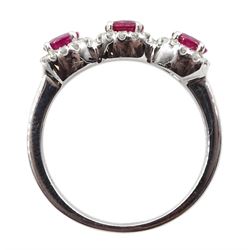 White gold three stone oval ruby and round brilliant cut diamond cluster ring, hallmarked