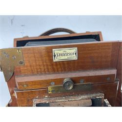 Ensign 'The Sanderson' folding plate camera in mahogany and lacquered brass, field model with canvas wrapped box, two mahogany photographic plates, 'Busch rapid Symmetrical F:8' lens,  and a wooden tripod 