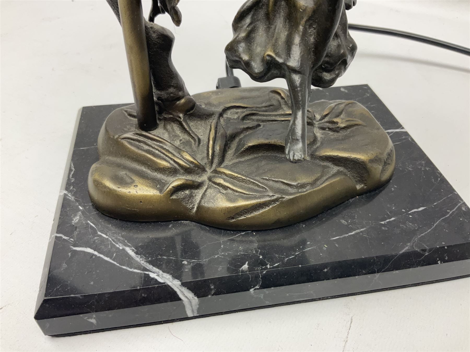 Art Nouveau style lamp in the form of a woman on a swing, with a green mottled shade, upon a marble base H52cm