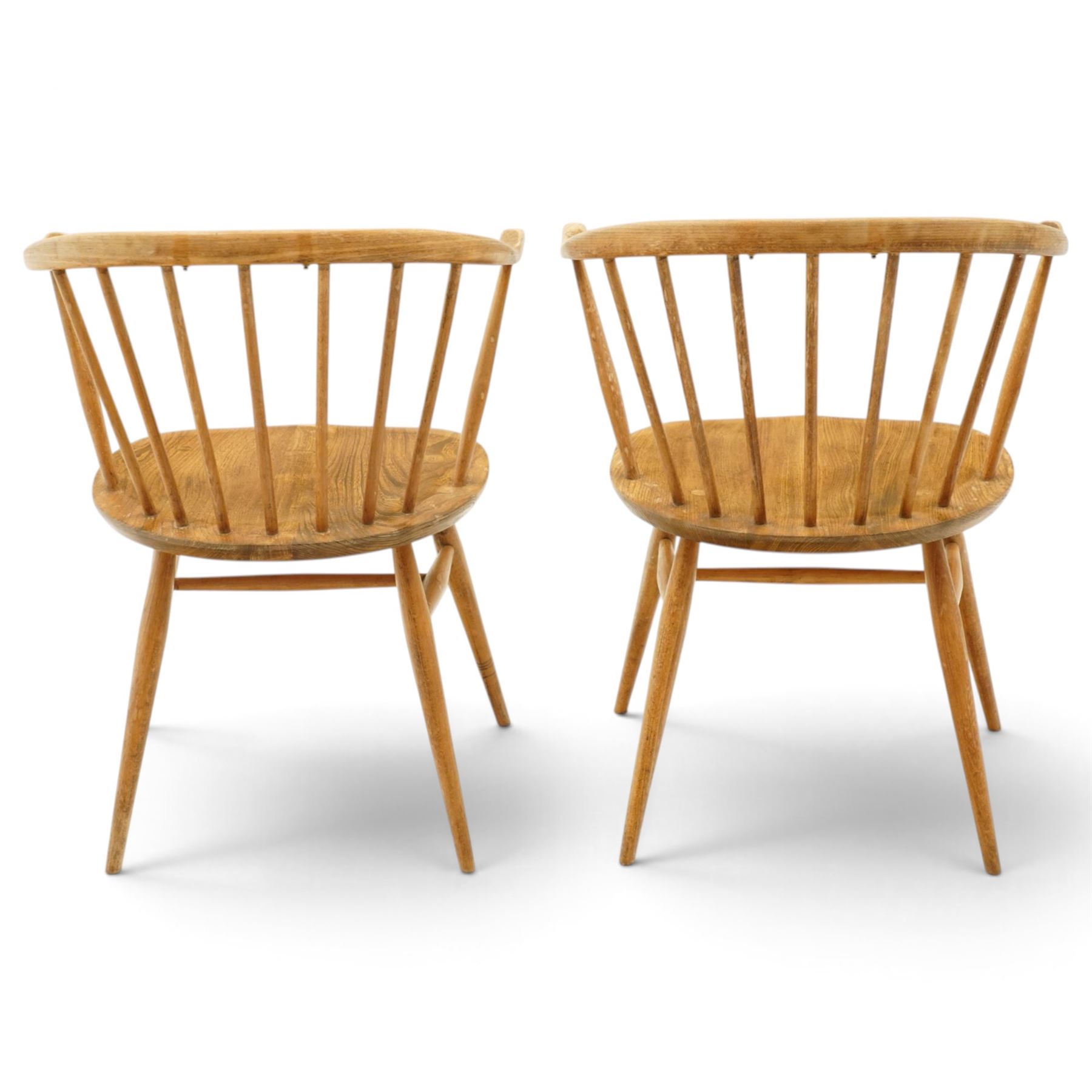Ercol - pair of 'Cowhorn' elm carver chairs, curved back raised on nine stretchers, elm dished seats, raised on tapering supports