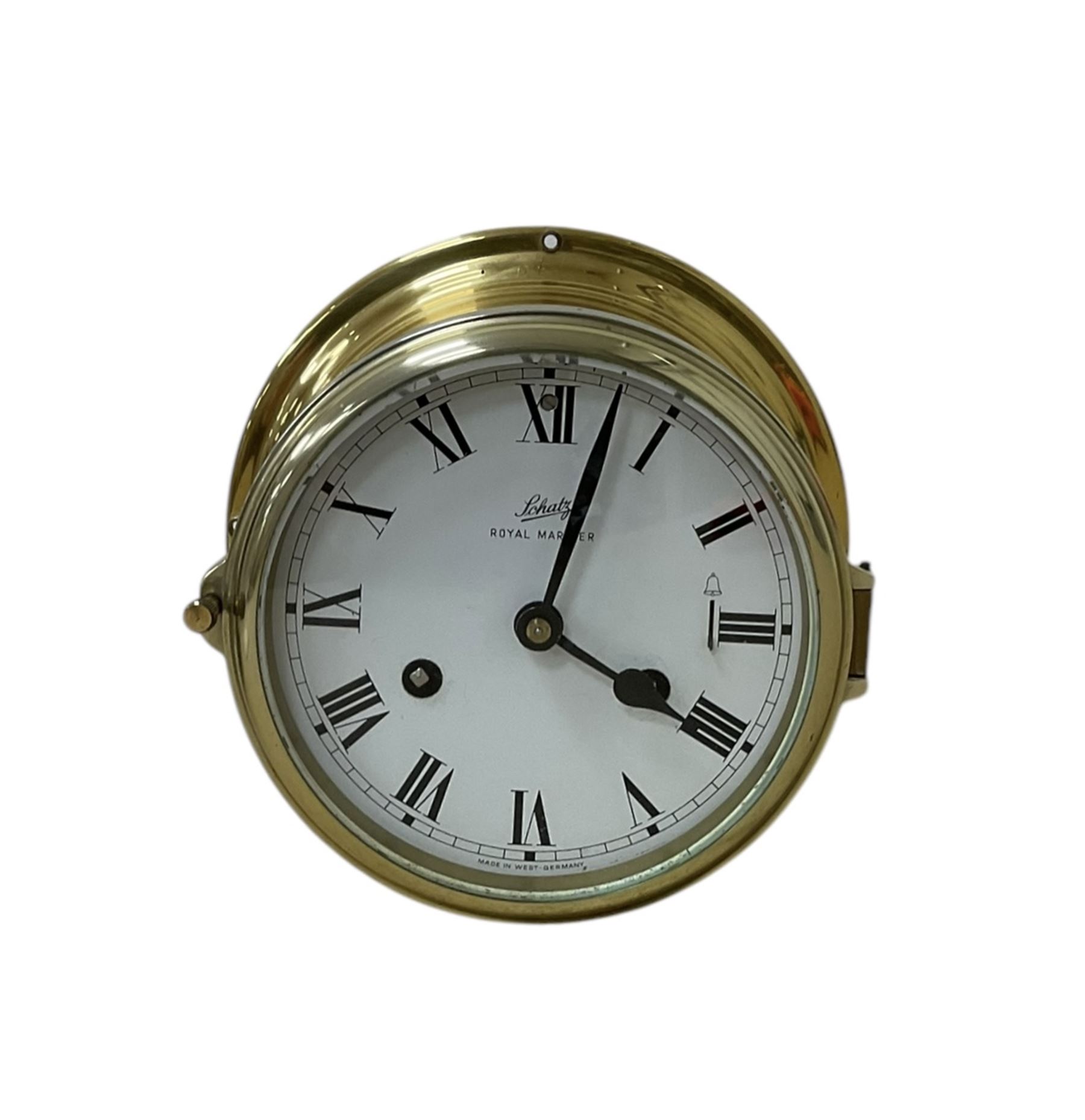 Schatz- 20th century Royal Mariner brass cased bulkhead mounted ships clock, twin train spring driven 8-day movement sounding the nautical watches on a bell, with a 5” dial, Roman numerals and spade hands. With key.  