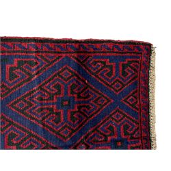 Persian Baluchi blue ground rug, decorated with geometric lozenges