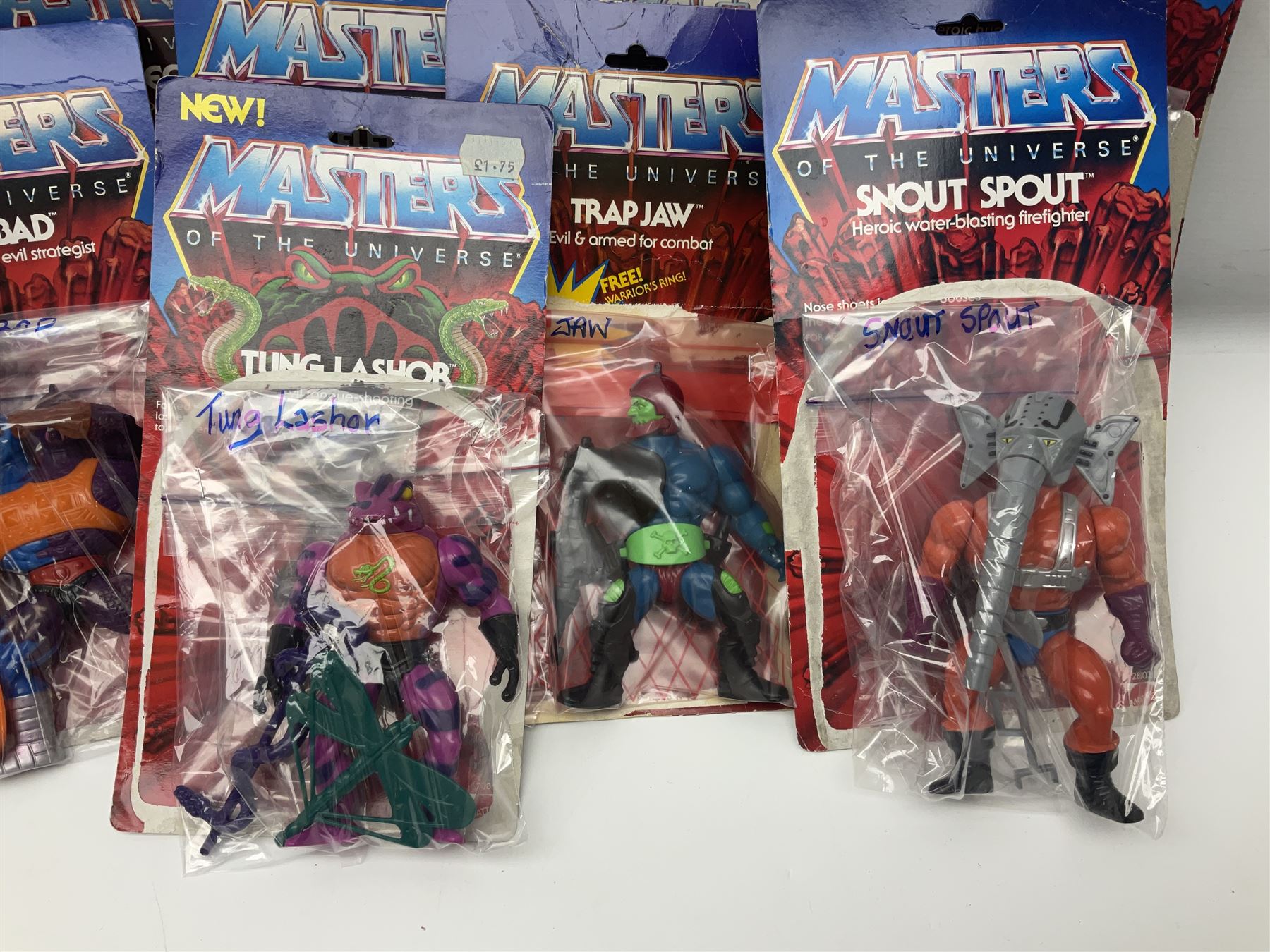 Thirty-one Masters of the Universe He-Man figures re-bagged on original backing cards;  two others lacking backing cards; boxed Modulok figure; bag of weapons and accessories; Roton, two horses and two battle cats; 1986 & 1987 Annuals; Ladybird and other story books; Panini sticker album; instructions etc