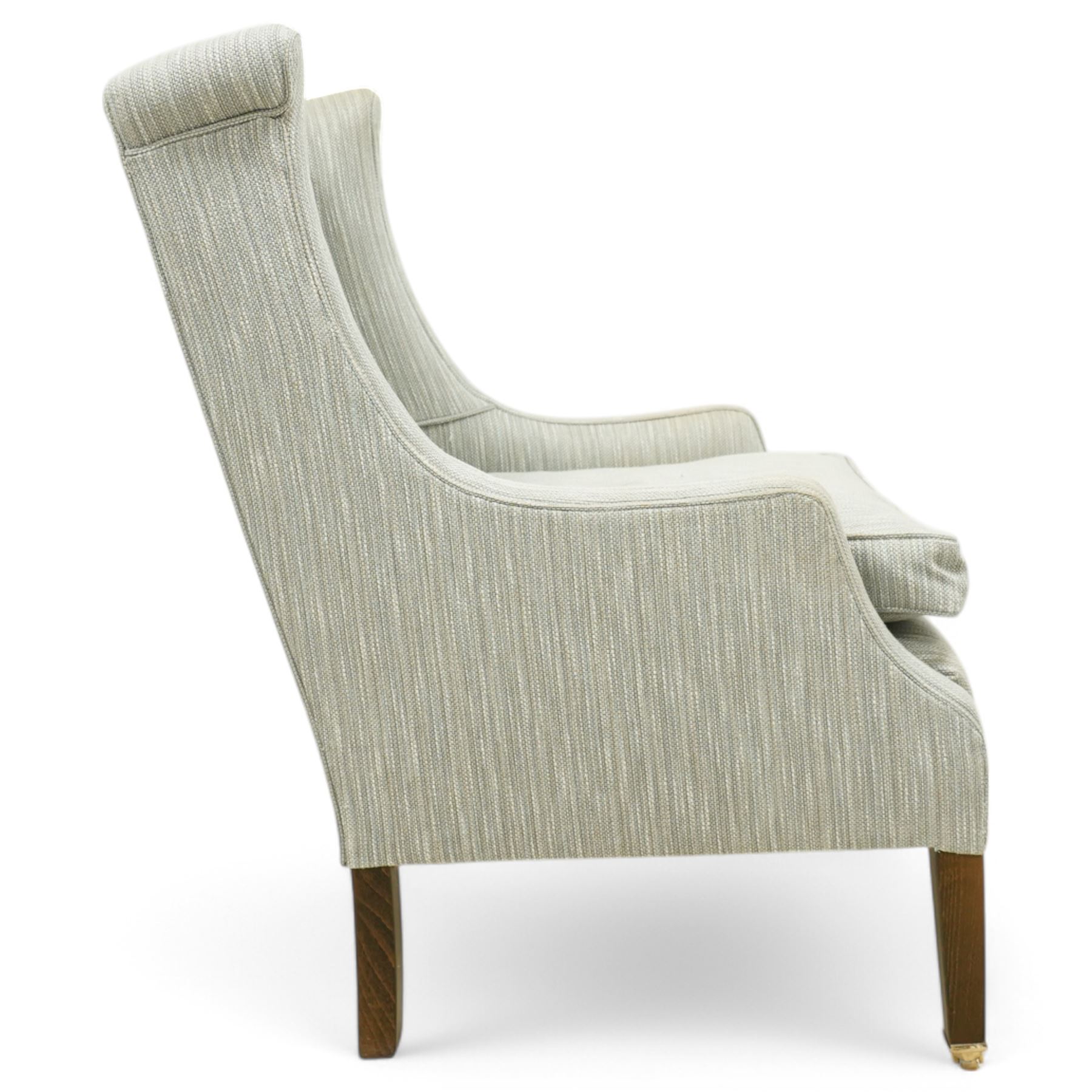 Whitehead designs - Edwardian design 'Tissington' wingback armchair on square tapering feet with castors, upholstered in natural fabric