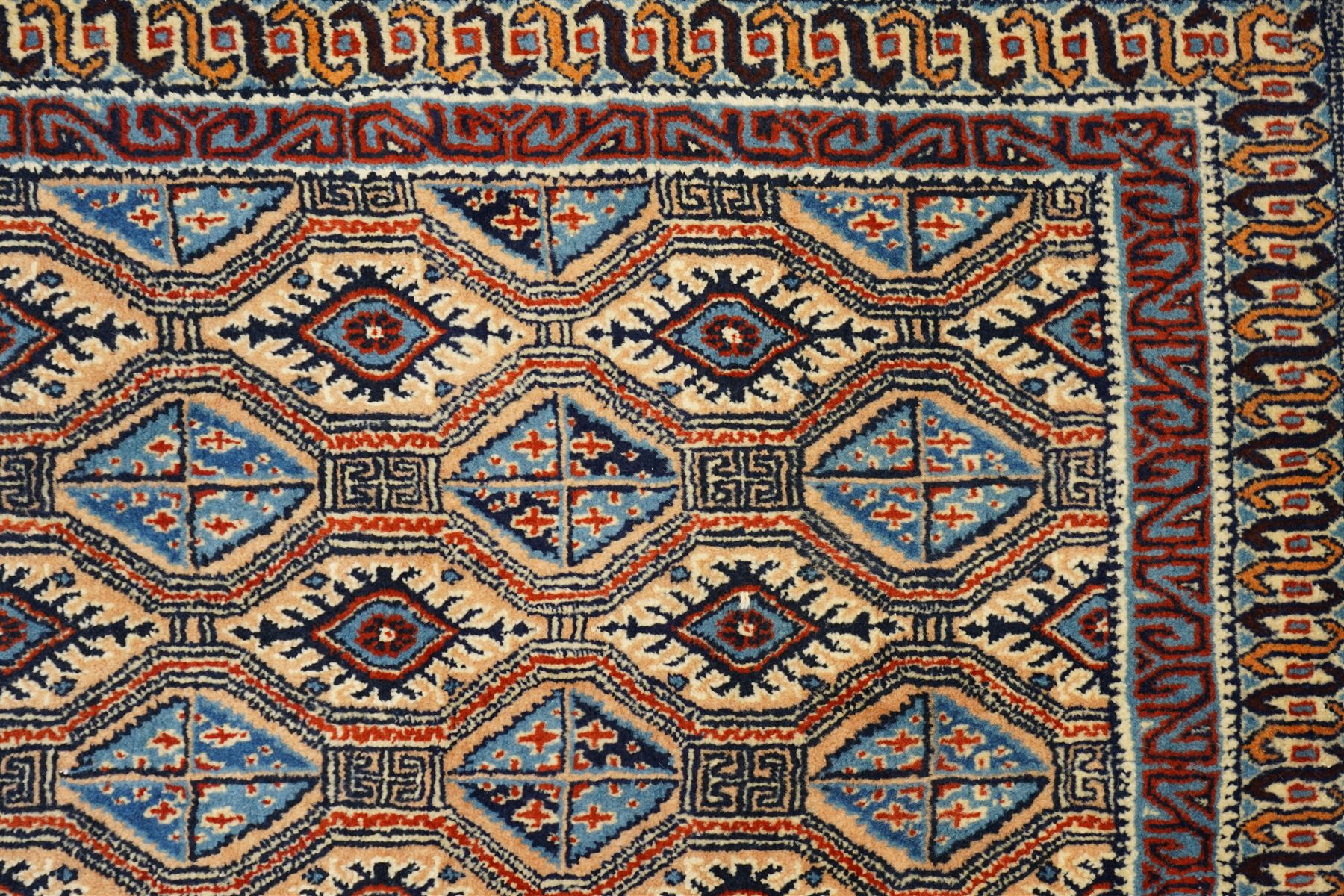 North East Persian Moud hand-knotted carpet, ivory field with an-over Herati inspired lattice of repeating lozenge and diamond motifs, with stylized floral devices and angular vinery in tones of sky blue, indigo, madder red and camel, principal border with a sequence of stylized palmettes and angular vine motifs, framed by narrow guard stripes, with cotton fringe ends