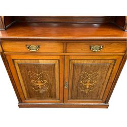 19th century inlaid mahogany bookcase on cupboard, swan neck pediment over three adjustable shelves, the base fitted with two drawers over two panelled cupboard doors, the facias inlaid with ornate urns surrounded by foliate