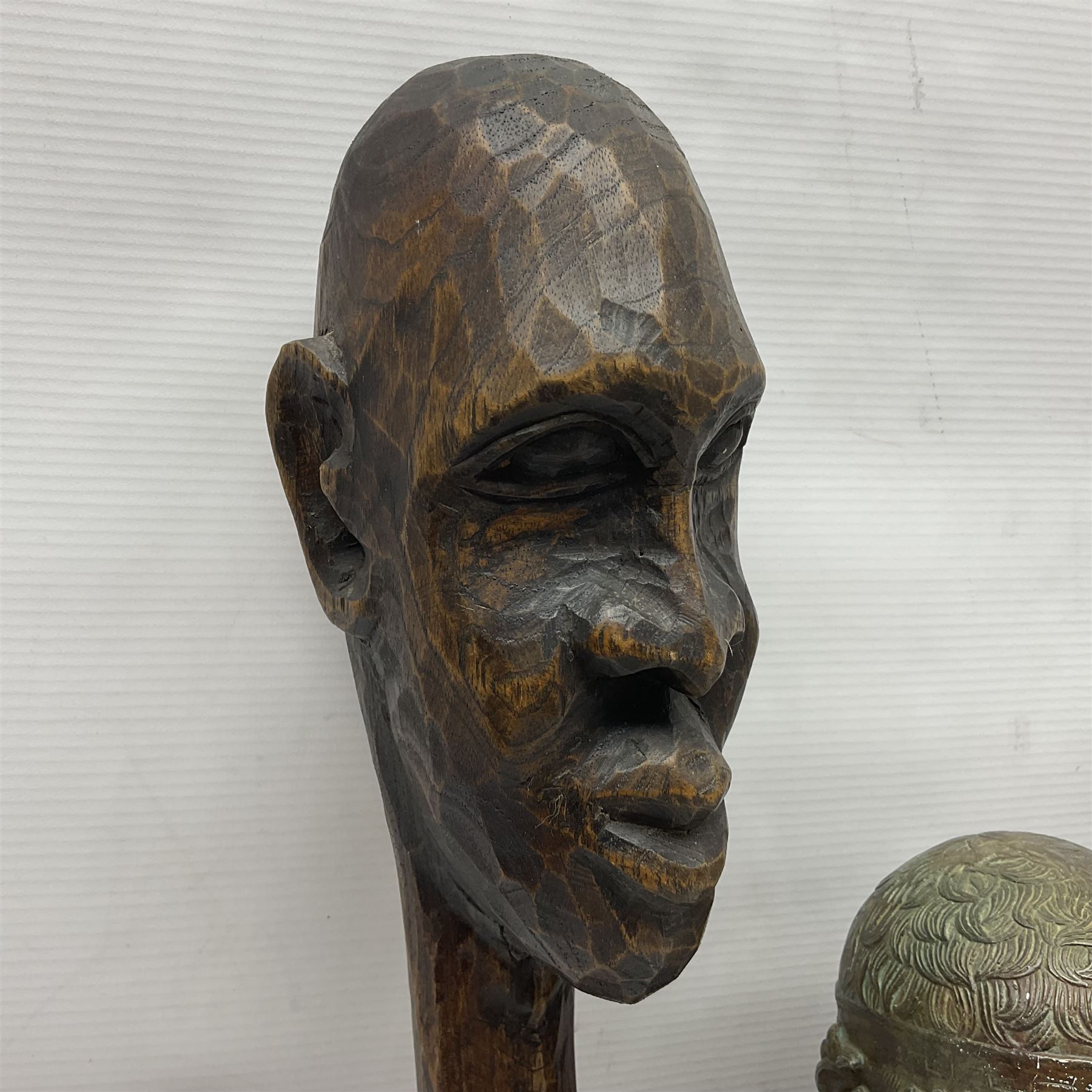 Bronzed bust of Greek man upon a marble base, together with two wooden sculptures 