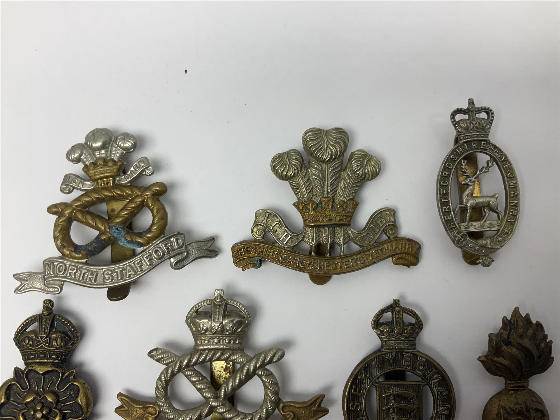 Nineteen Yeomanry metal cap badges including Derbyshire, Northamptonshire, Essex, Glamorgan, Staffordshire, City of London, Surrey, Shropshire, Hertfordshire etc; together with eleven Fusiliers badges including Lancashire, Royal Welch, Northumberland etc (30)