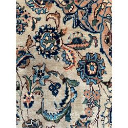 Persian Kashmar camel ground carpet, palmette rosette medallion on a field of curling leafy branches and stylised plant motifs, scrolling border decorated with further palmettes, within floral pattern guard stripes