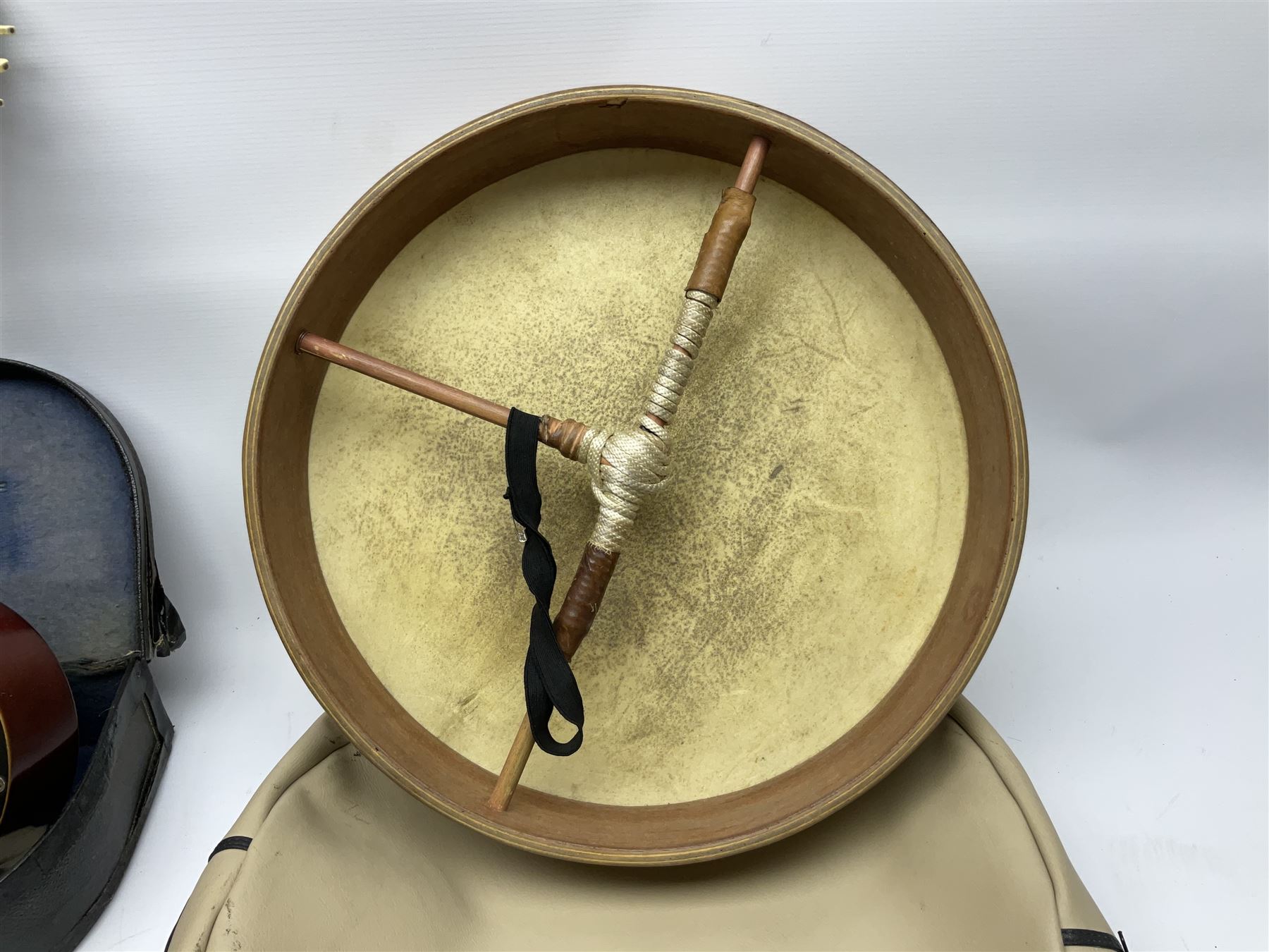 Dulcet eight-string banjo mandolin with mother-of-pearl inlaid ebonised fingerboard L55.5cm; cased; and Irish mahogany bodhran hand drum with inlaid stringing and vellum top D46.5cm; in soft carrying case with double ended beater (2)