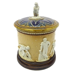  Doulton Lambeth stoneware tobacco jar & cover, continuous relief moulded band featuring men in fielding, batting and bowling poses against a salt-glazed ground, the cover surmounted by a figure of a seated batsman c1880, impressed marks H16.5cm   