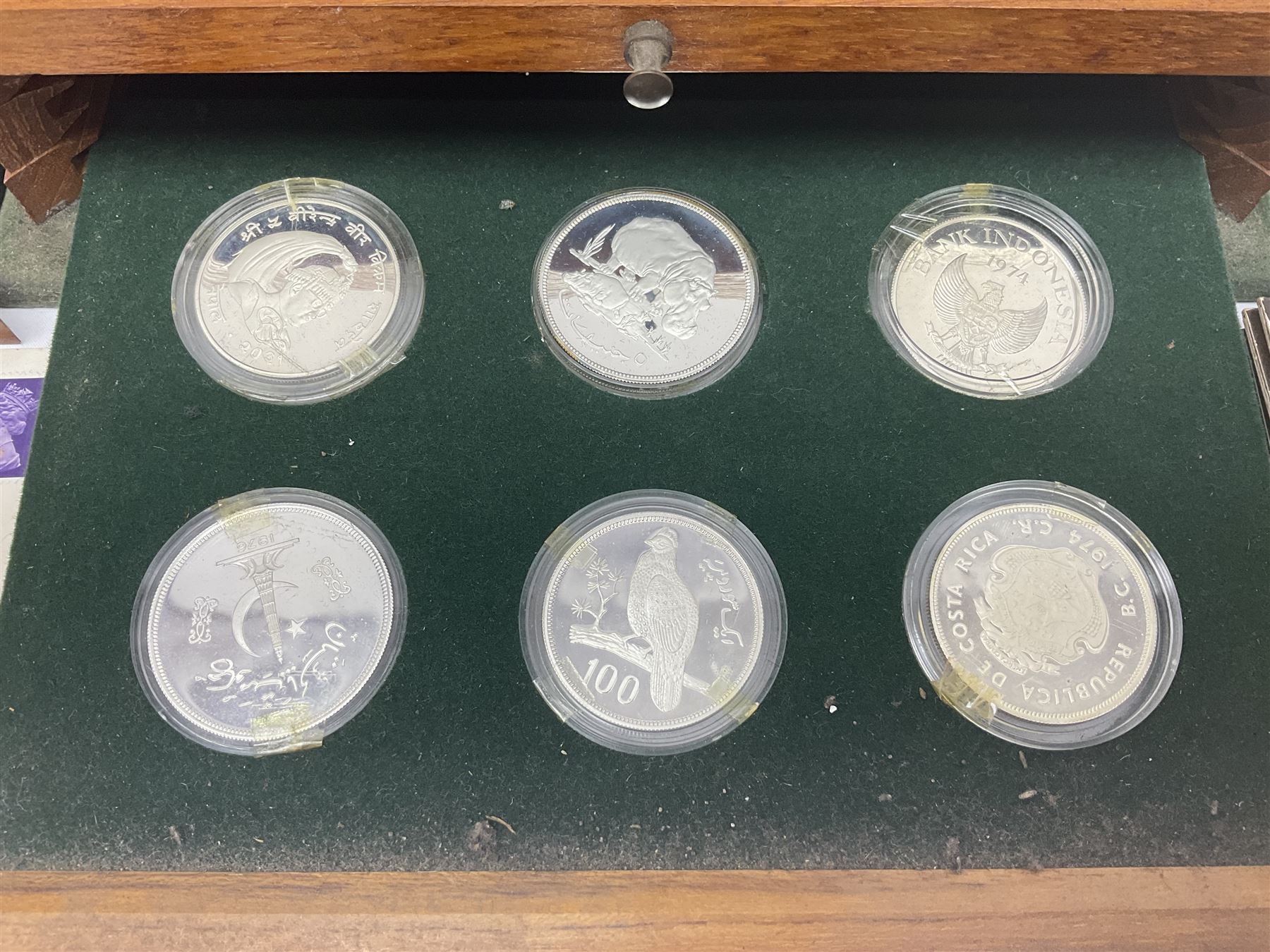 The Royal Mint 'Conservation Coin Collection' formed of twenty-four silver proof coins, housed in the wooden display case, with information booklet