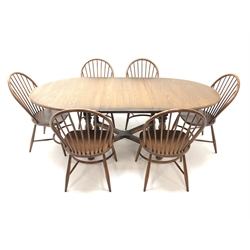  Ercol Golden Dawn finish elm extending oval dining table, turned supports joined by an 'X' stretcher (W215cm, H75cm, D108cm) and set six hoop back chairs (W50cm)  