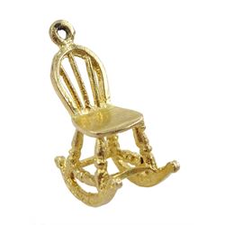 Four 9ct gold pendant/charms including paddle wheel steam boat, wicker trolley basket, rocking chair and cart, all hallmarked