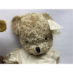 Two early 20th century straw filled jointed teddy bears, first example wearing a tweed jacket bearing Geoffrey Saville label, with leather padded paws and ears, horizontally stitched nose and humpback; second example with applied eyes, vertically stitched nose and faux leather paw pads, both with growler mechanisms, tallest H74cm 