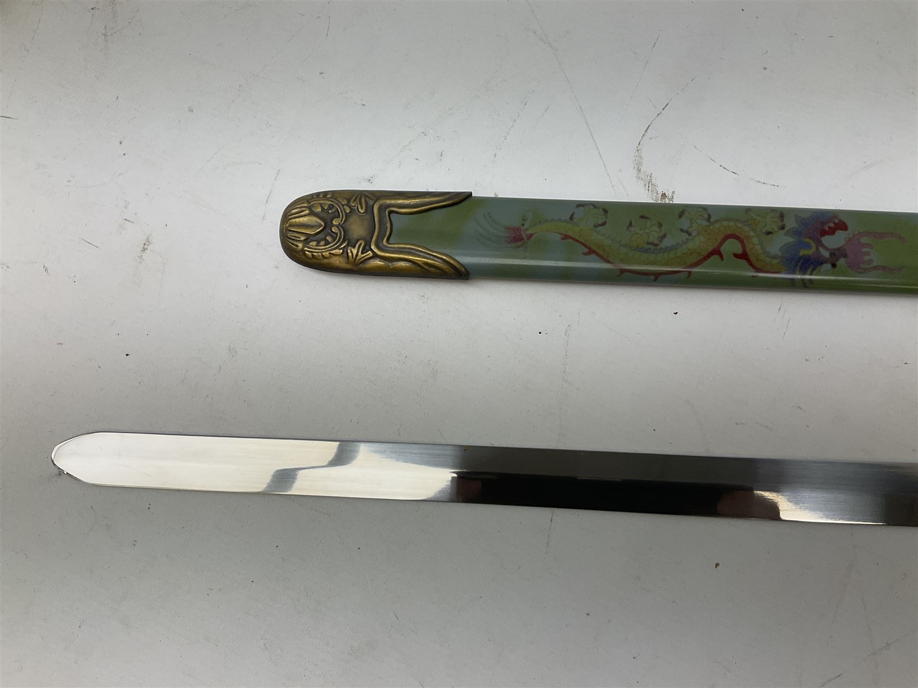 Three reproduction swords - Japanese katana and saya; Tai Chi sword with ornate scabbard; and dress sword with fullered triangular blade and horn handle (3)