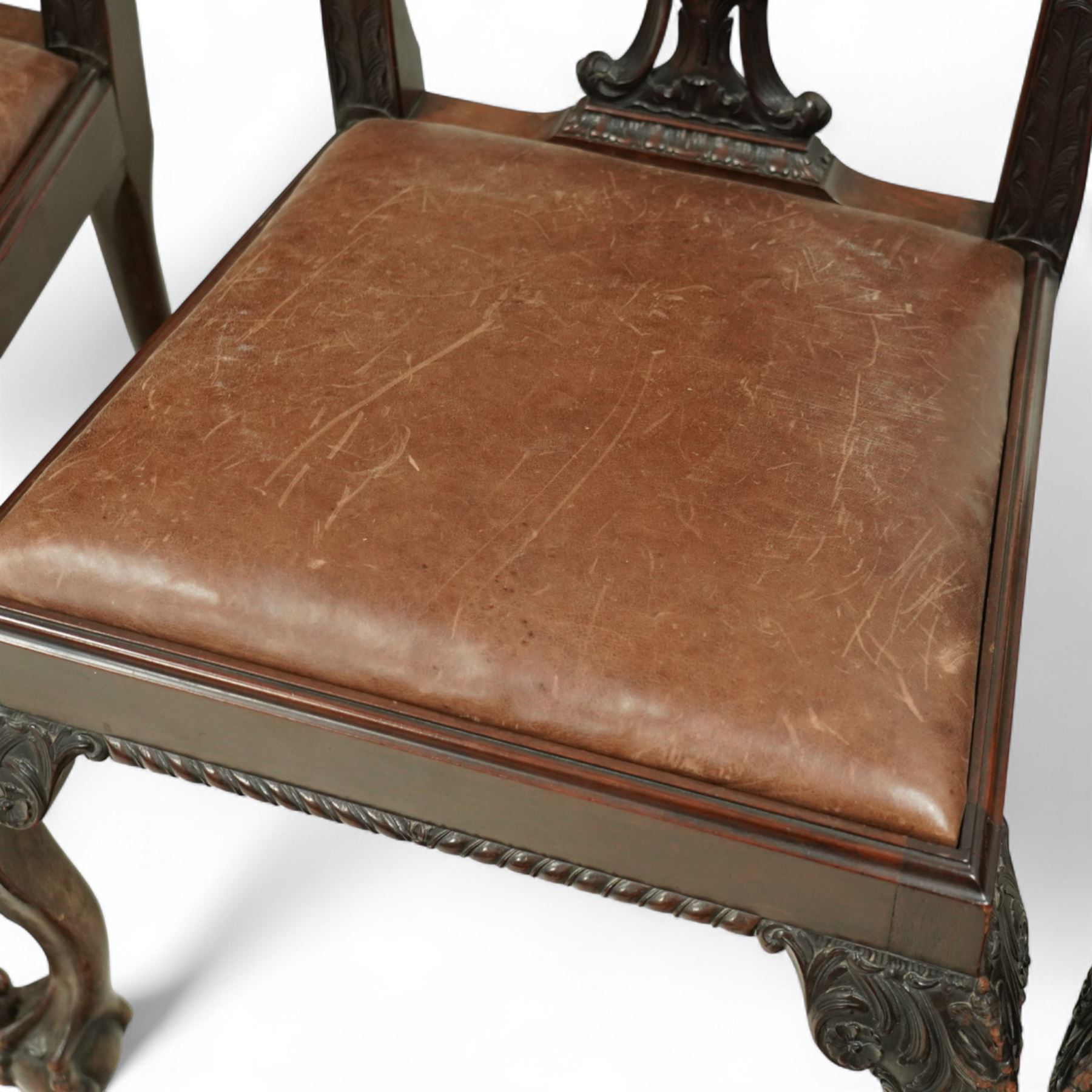 Set of eight 20th century Chippendale design mahogany dining chairs, including two carvers, each with pierced ribbon back splat carved with acanthus leaves, drop-in leather upholstered seats, moulded seat rails, on cabriole legs with ball and claw feet