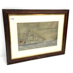 Victorian woolwork picture of an English three-masted warship flying the Red Ensign and other flags, depicted at sea close to the coast with a small sailing vessel in the foreground, 31 x 49.5cm, simulated rosewood frame