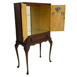 Mid-20th century walnut cocktail cabinet, two figured doors enclosing mirrored interior, fitted with single drawer, on acanthus carved cabriole supports