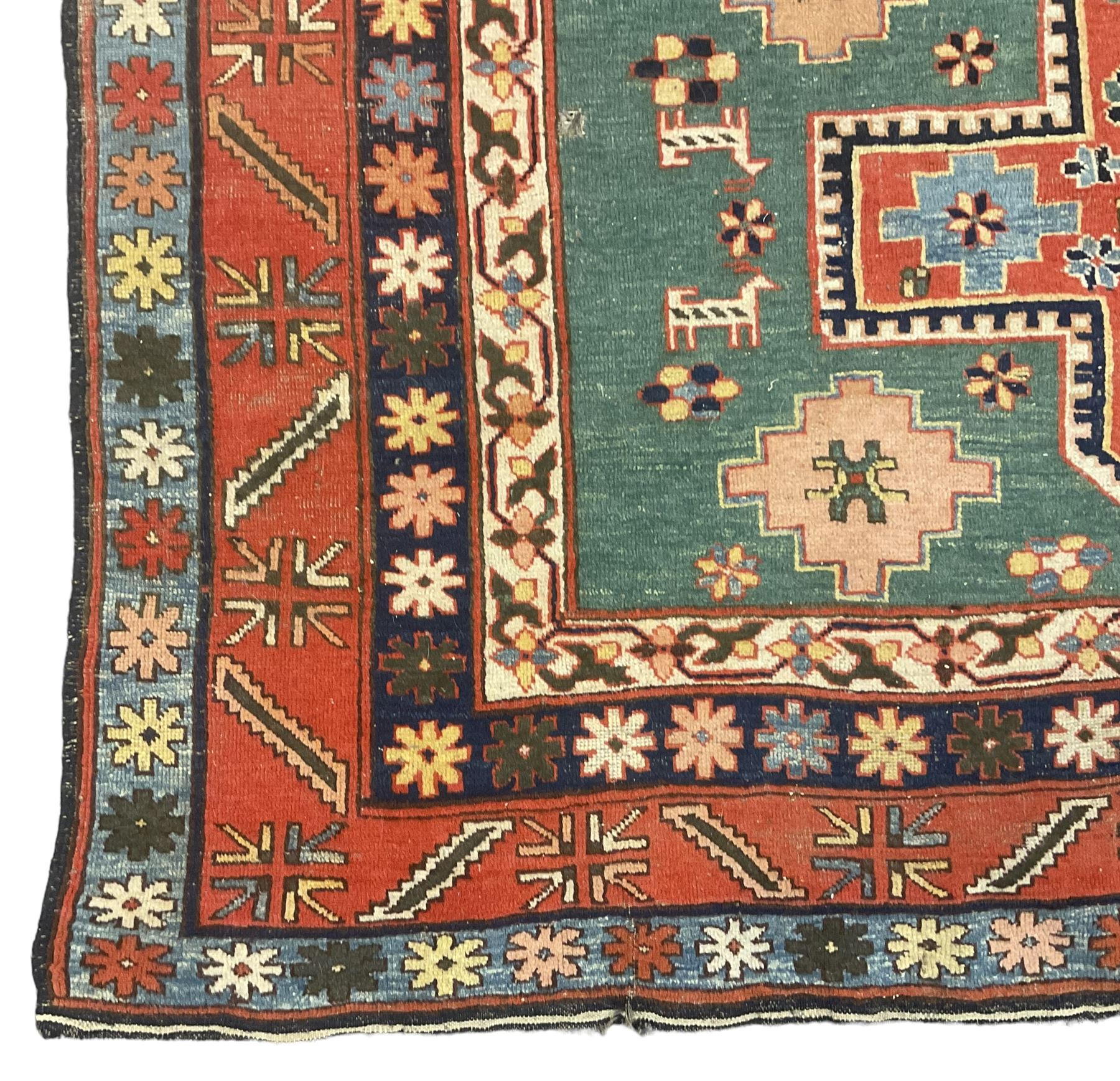 Caucasian turquoise ground rug, two medallions on a field decorated with stylised animal and geometric motifs, the guarded border decorated with further geometric motifs