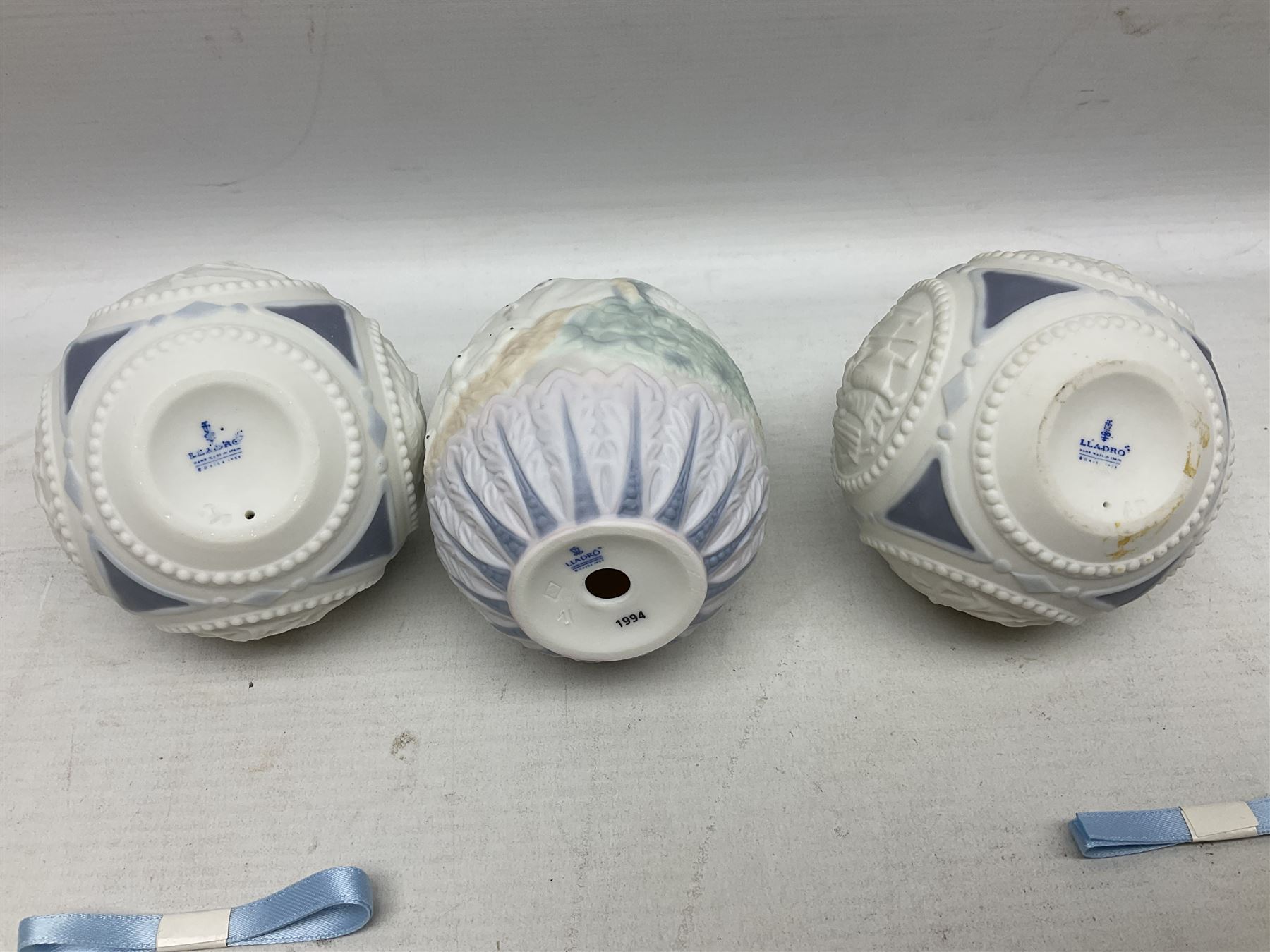 Seven Lladro bells, comprising Summer no 17614, Fall 17615, Christmas 1988 no 5525, Christmas 1989 no 5616,  Christmas 1990 no 5641, Christmas 1992 no 15913 and Christmas 1993 no 16010, together with two Lladro Christmas balls no 1603 and Lladro easter eggs 1994 no 17532