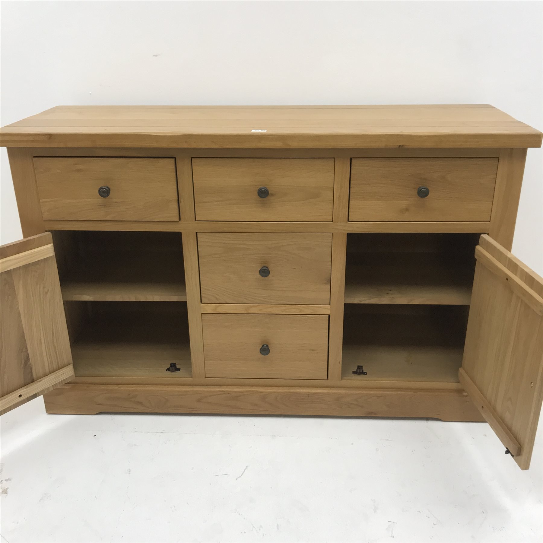 Light oak sideboard, five drawers, two cupboards, plinth base, W143cm