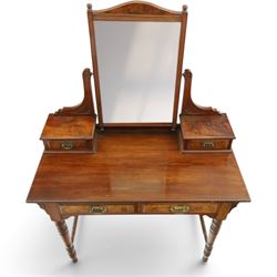 Late Victorian figured walnut and mahogany dressing table, raised swing-mirror back over trinket drawers, fitted with two drawers with brass Aesthetic Movement handles, on ring-turned supports with ceramic castors