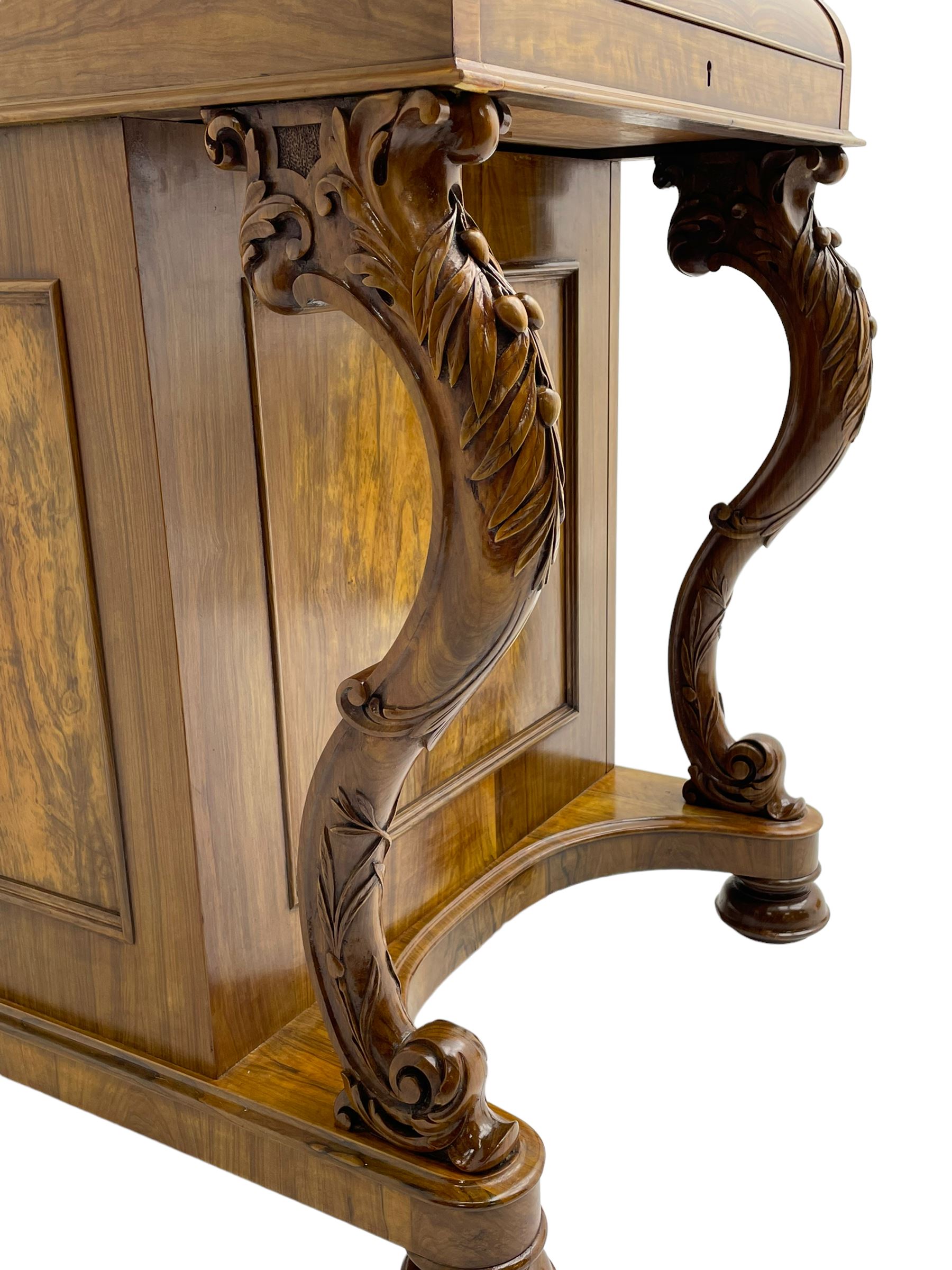 Fine and unusual 19th century olivewood piano top davenport, raised shaped back carved with olive branches and olives, the top hinges to reveal lidded and correspondence compartments, the piano lid enclosing sliding top with hinged and adjustable writing surface with leather inset, right-hand panelled door enclosing four drawers, olive branch and scroll carved cabriole front supports on moulded and shaped platform, turned cup feet with recessed castors 