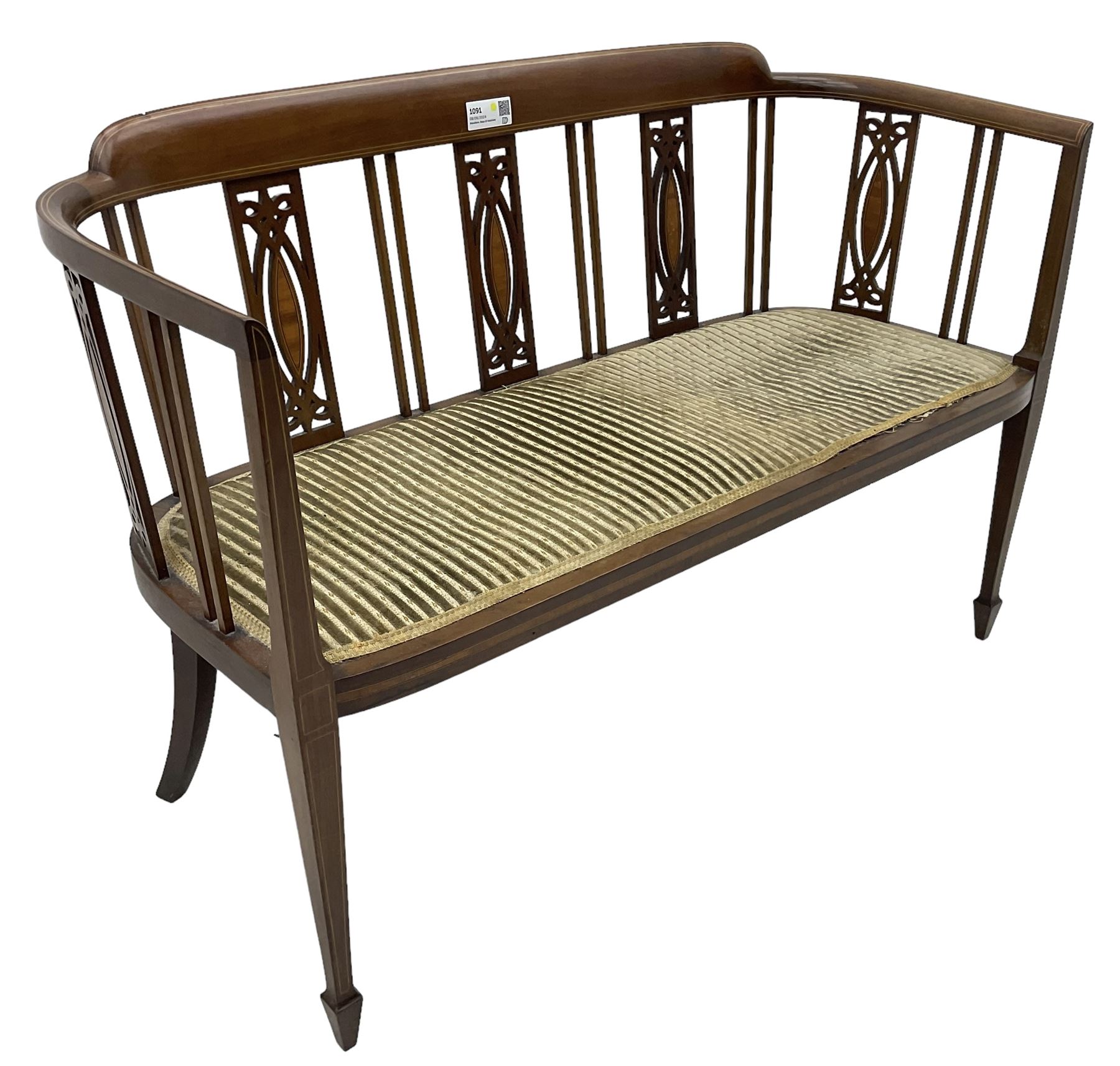 Edwardian inlaid mahogany two-seat salon sofa, curved back and arms inlaid with boxwood stringing, vertical slat back with pierced splats inlaid with satinwood, upholstered seat, on square tapering front supports with spade feet 