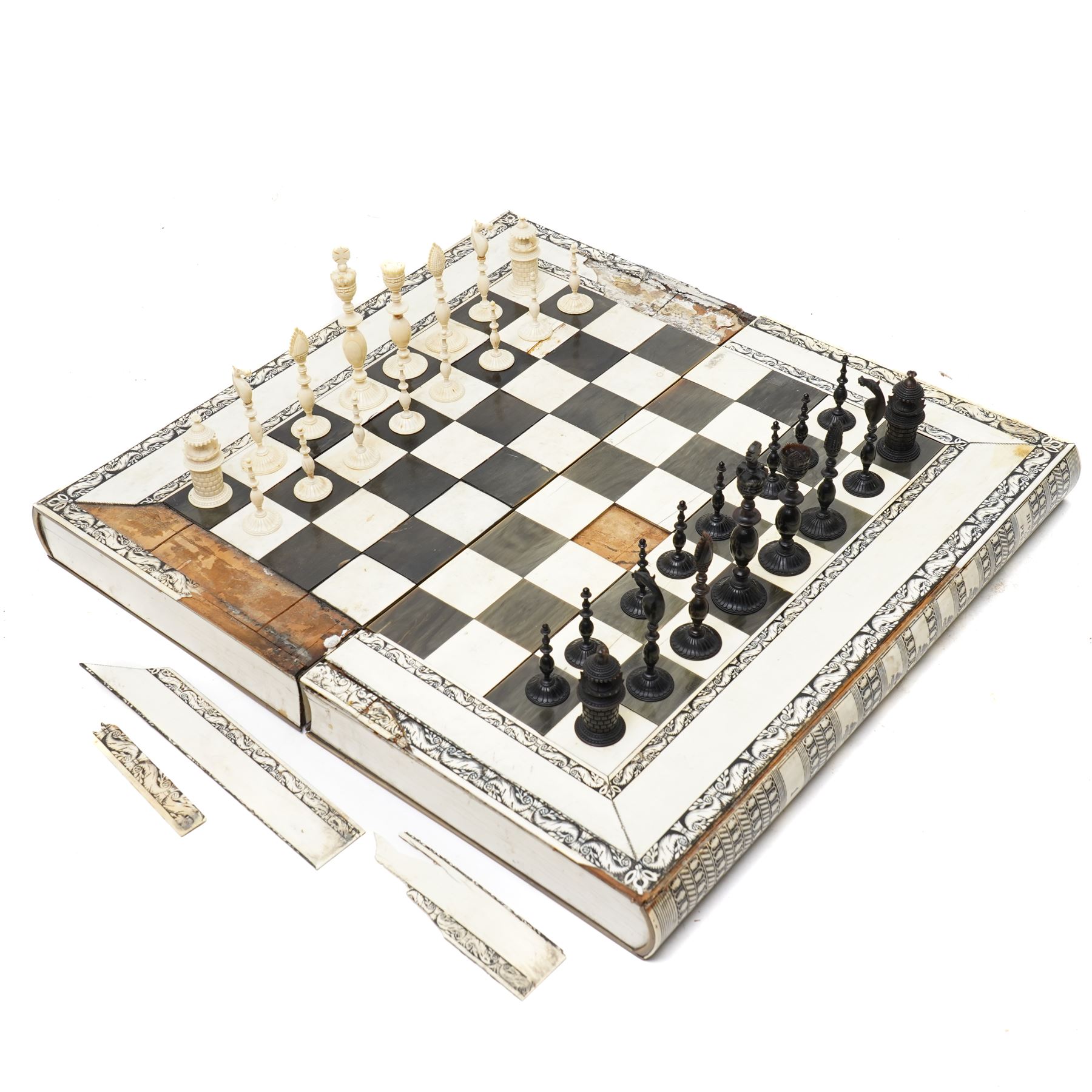 Mid-19th-century Anglo Indian Vizagapatam ivory, sandlewood, and horn veneered backgammon/chess board, circa 1860, rectangular games box the borders engraved with a stylized scrolling leaf decoration and spine engraved History of Persia the interior inlaid for backgammon, with three internal sandalwood boxes with covers, containing 16 ivory pieces and 16 horn pieces, comprising, kings and queens with pierced crowns on baluster carved shafts; bishops with carved mitres; knights represented by horses’ heads; and rooks as towers with imbricated decoration.

This item has been registered for sale under section 10 of the APHA Ivory Act, submission reference G68PNYA5 

