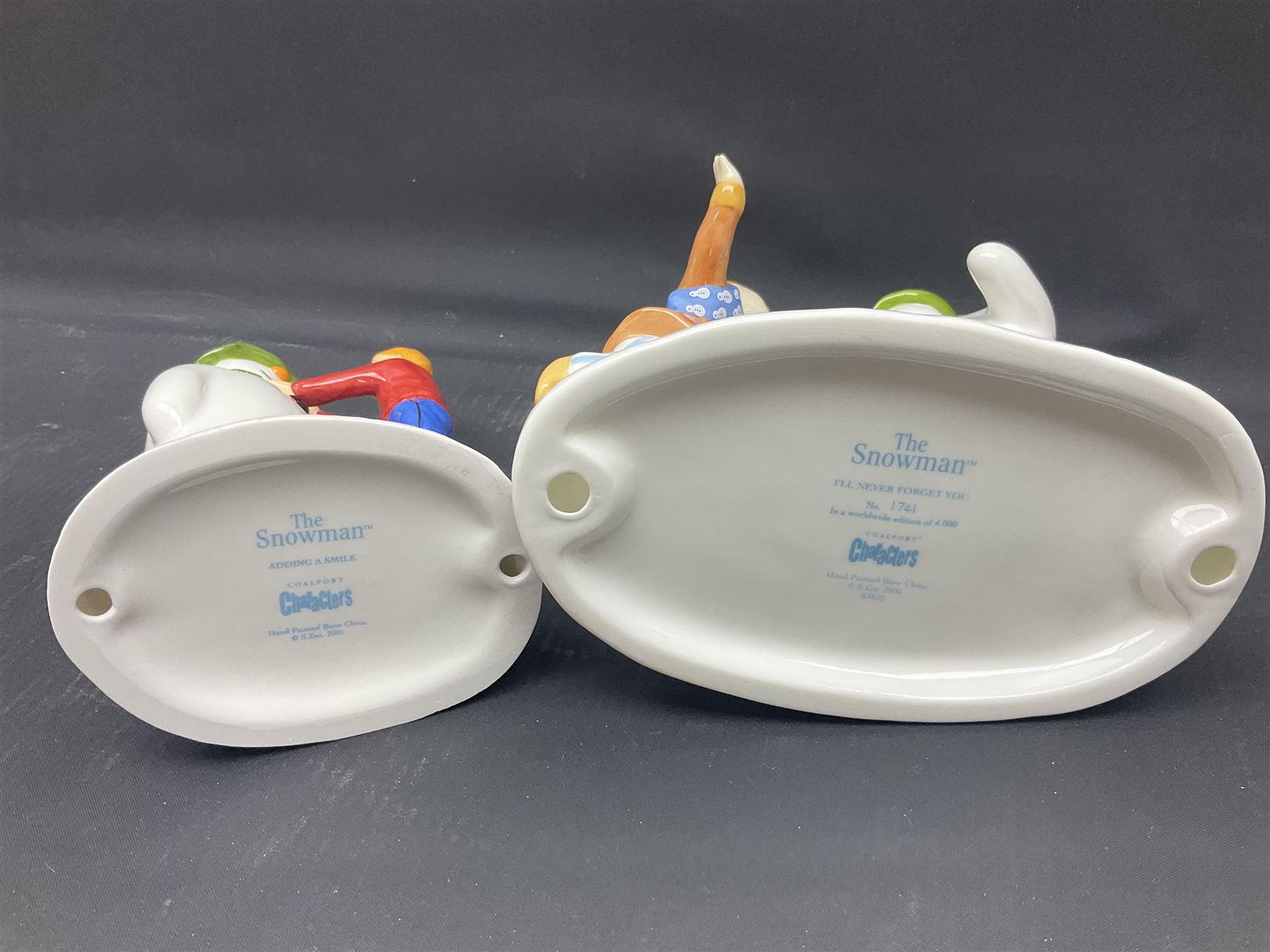 Four Coalport Characters The Snowman figures, comprising I'll Never Forget you with certificate, Pulling a Cracker and Adding a Smile, all with original boxes