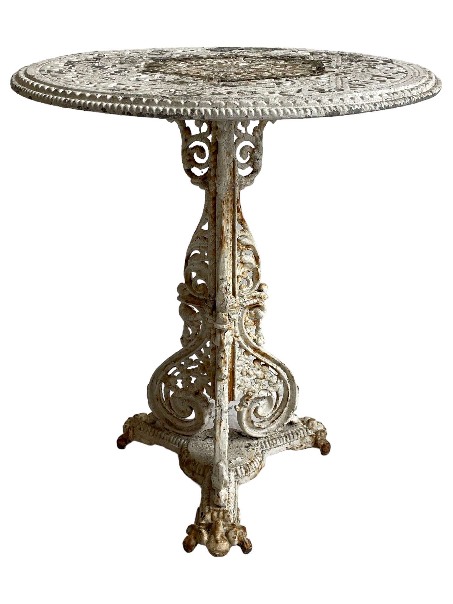 Coalbrookdale design - 19th century cast iron and cast alloy garden table, circular top with beaded edge pierced with scrolls, the pedestal decorated with scrolling and foliate motifs triple arm platform bass with scrolled feet