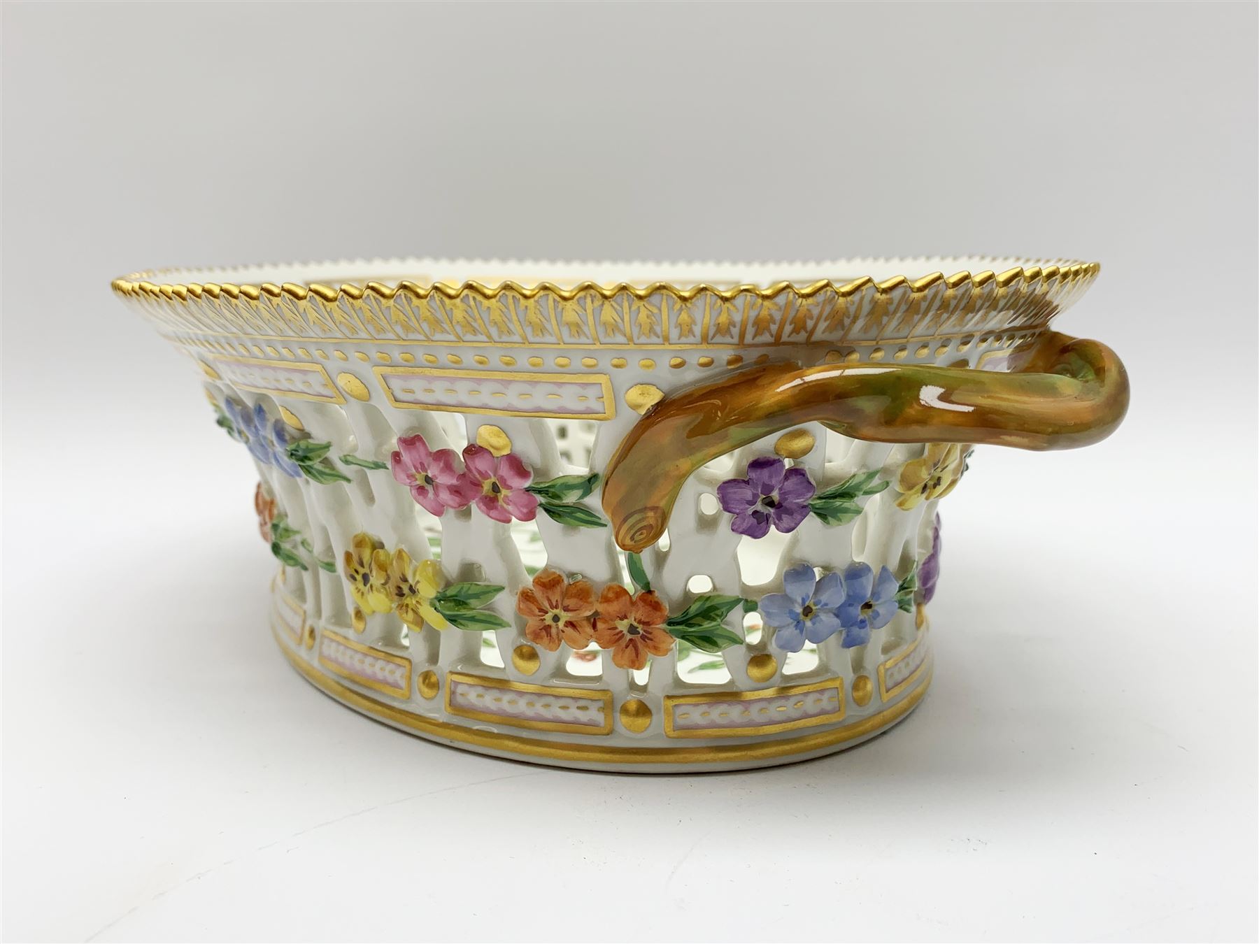 Royal Copenhagen Flora Danica basket, with naturalistically modelled vine handles and reticulated sides detailed with polychrome forget-me-nots, the interior decorated with a botanical study of 'Anagallis arvensis', sprigs and a gilt border, with printed and painted marks beneath, H8cm L26cm 


