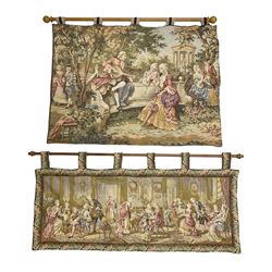 Two tapestry style panels, the first depicting Georgian scene of a gentleman serenading two ladies with a lute in a garden setting, together with a further example depicting a soiree scene with well dressed ladies and gentlemen within a foliate border, both suspended from wood poles and lined, widest W140cm H65cm