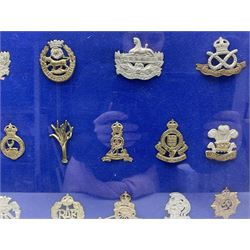 Twenty-eight glengarry and cap badges including Gordon Highlanders, Black Watch, Cameron, Lancashire Fusiliers, East Surrey, Gloucestershire, Welsh Guards, RAMC, Royal Artillery, Signal Corps, The Welch, RAF, Royal Engineers, York & Lancaster, US Army Officers Eagle etc; mounted and framed for display