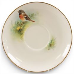 Royal Worcester large novelty cup and saucer, each hand pained, the cup with grouse, the saucer with stonechat