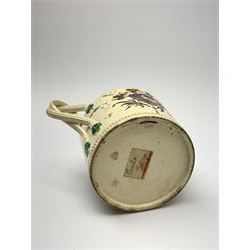 18th century creamware teapot, probably Leeds, with reeded entwined handle and floral finial to the cover, the body with hand painted polychrome decoration of figure to one side, and floral spray to the other, collectors paper label beneath inscribed Leeds Pottery, H11.5cm