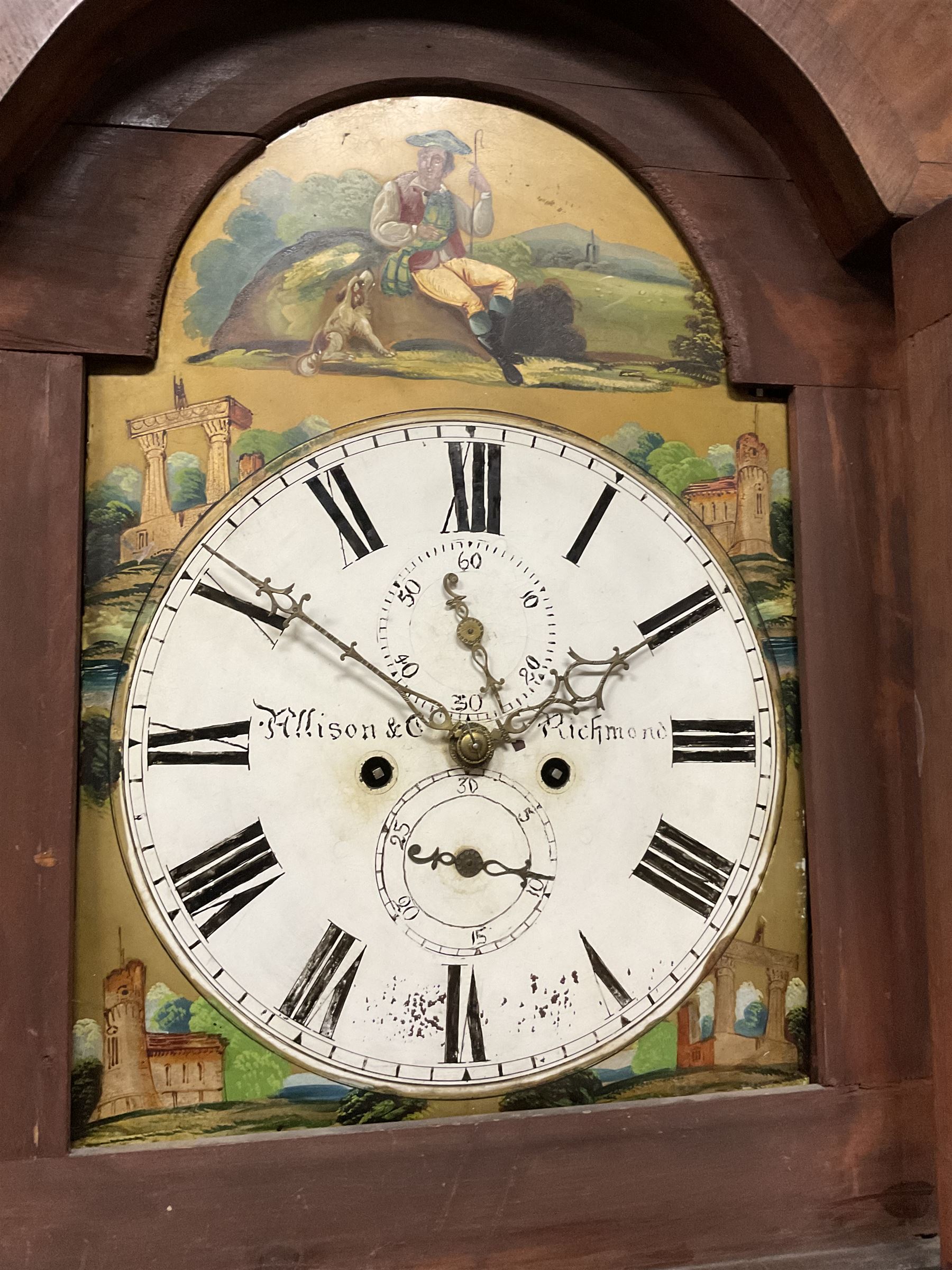 Francis Allison & Co. Finkle Street Richmond - late 19th century 8-day mahogany veneered longcase clock, with a swan’s neck pediment and break-arch hood door flanked by ring turned pillars, broad trunk with cushion moulding and recessed half-pillars to the sides, short trunk door with carved cresting to the top, rectangular plinth with conforming side pillars, fully painted 13” dial with matching brass hands, Roman numerals, minute track, subsidiary seconds and date dials, diagonally matched painted  spandrels and a depiction of a seated shepherd to the break arch, dial pinned directly to an eight-day rack striking movement, striking the hours on a bell. With weights and pendulum. 