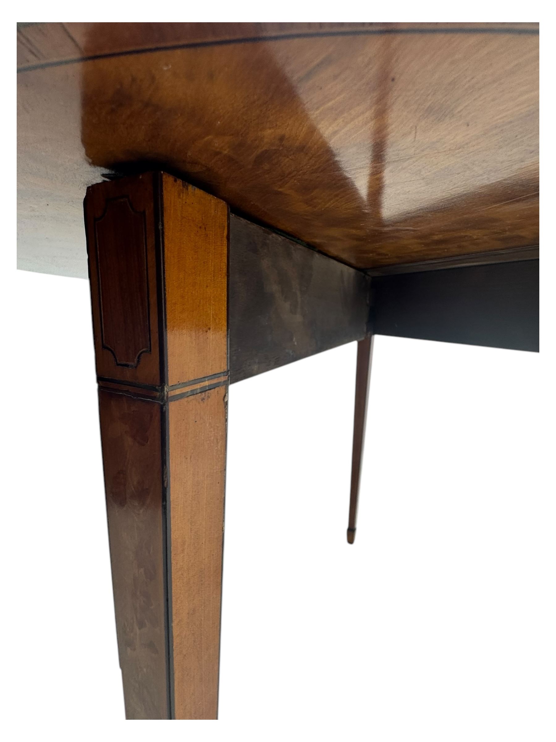 Edwardian satinwood inlaid demi-lune card table, hinged fold over green baize lined interior, raised on square tapered supports with spade feet  