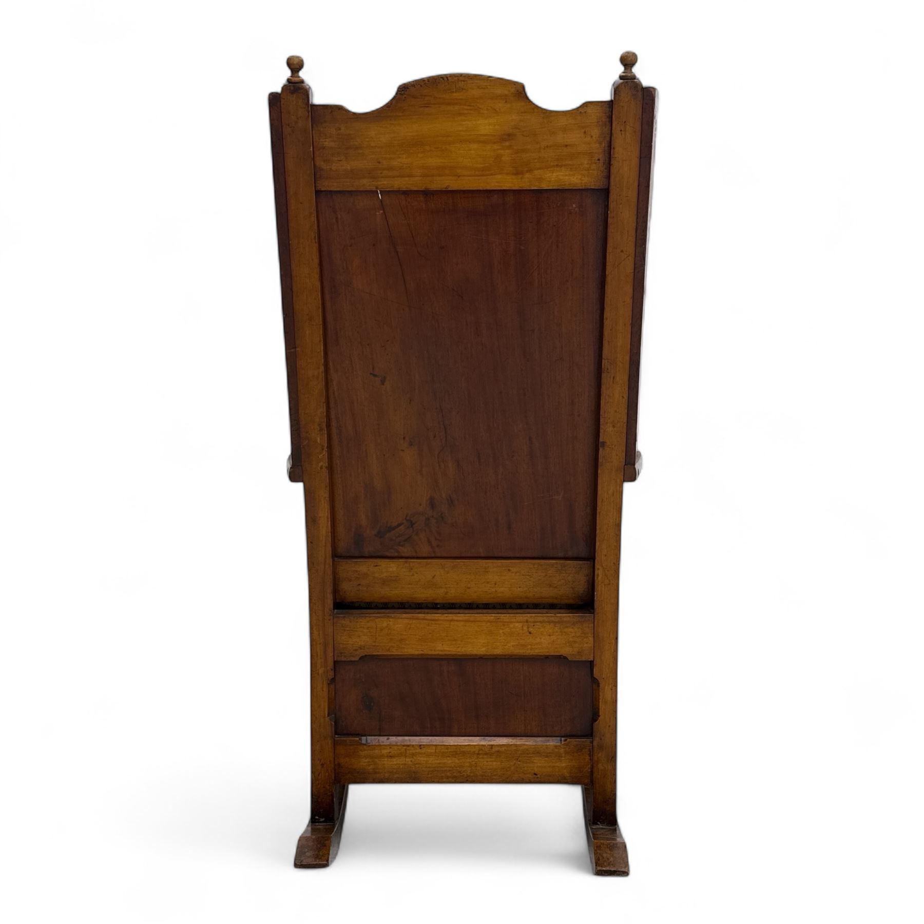 19th-century beech, yew, elm, and mahogany wingback vernacular rocking chair, high back with shaped wings, scroll arms with turned supports, lift-up seat,  square legs on ring turned supports on curved runners 