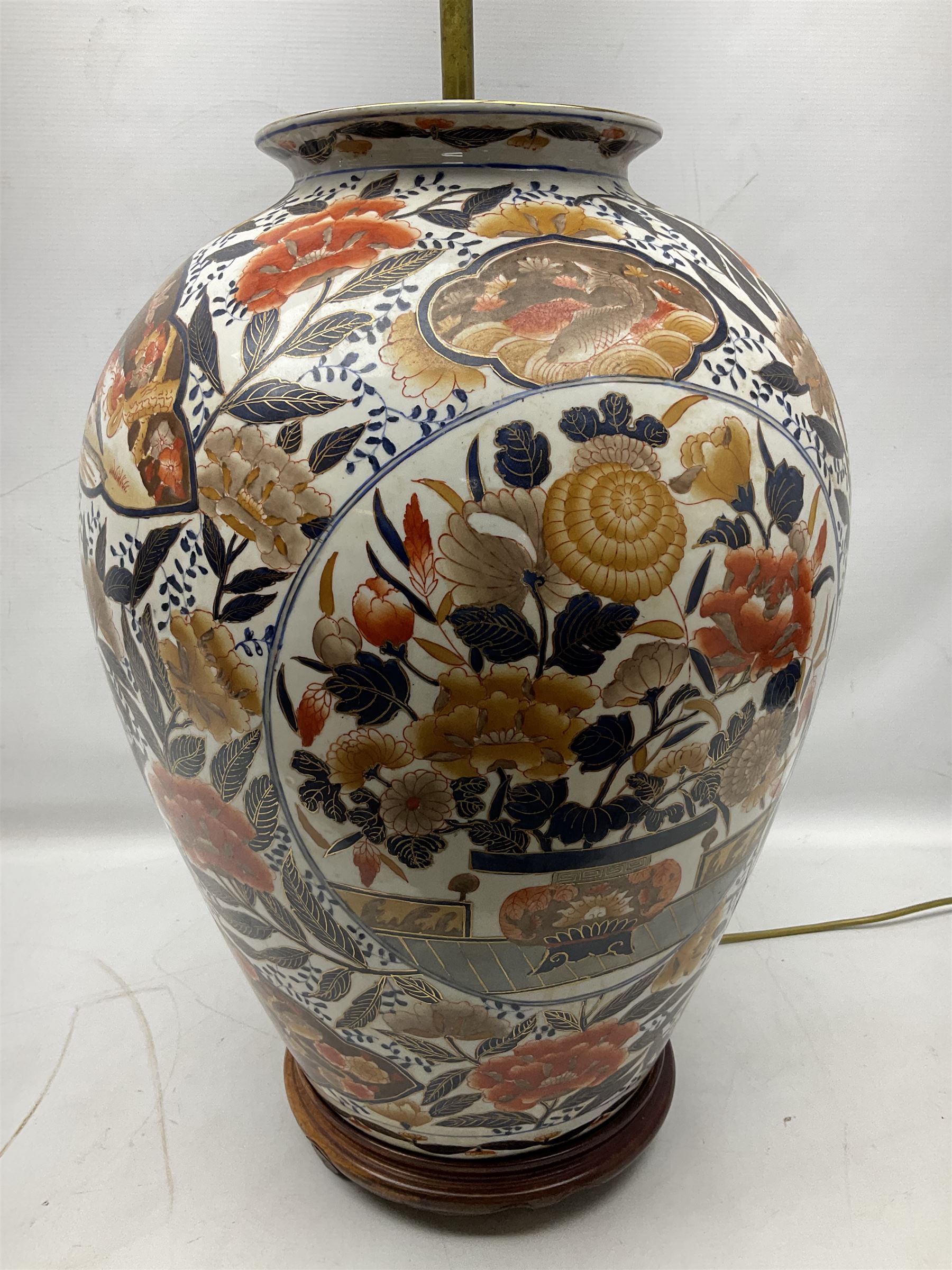 Pair of large and impressive 20th century Japanese Imari table lamps, each of ovoid form, decorated in the Imari palette with roundels containing flowering urns, and shaped panels of birds, set against a white ground decorated with blossoming peonies, lamp base (not including fixtures) H56.5cm overall including shade H89cm