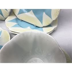 Shelley Dainty pattern tea wares, of lobed form with blue star decoration on merging white and yellow ground, comprising five teacups, five saucers, six tea plates, milk jug and cake plate, all with printed green mark beneath, some with painted pattern no 11770
