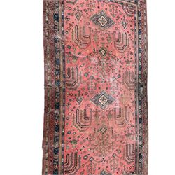 Large early 20th century Turkish red ground carpet, the field decorated with stylised plant motifs, multiple band border decorated with flower heads and repeating patterns 