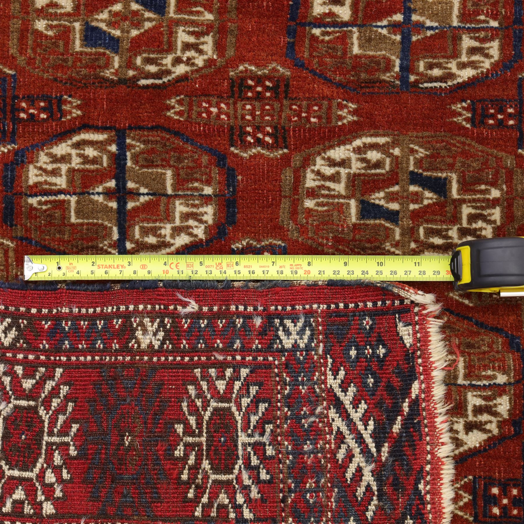 Tekke Turkman rug, madder red field decorated with repeating rows of octagonal guls, framed by multiple geometric borders, 86x133cm and an Anatolian flatweave kilim, 95x140cm, (2)