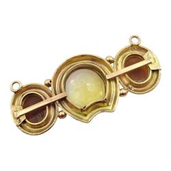 Victorian 15ct gold mounted citrine and cameo pendant, the central horseshoe shaped citrine with laurel leaf surround flanked by two Classical figure cameo's