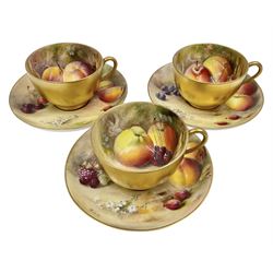 Set of three early 20th century Royal Worcester tea cups and saucers decorated by William Ricketts, each cup with gilt exterior and loop handle, the interior hand painted with a still life of fruit upon a mossy ground, signed Ricketts, each saucer with conforming hand painted decoration, and central gilt circular well and gilt rim, signed Ricketts, each with puce printed mark beneath and date codes for 1917 and 1918, cups D8cm H5.5cm saucers D14cm