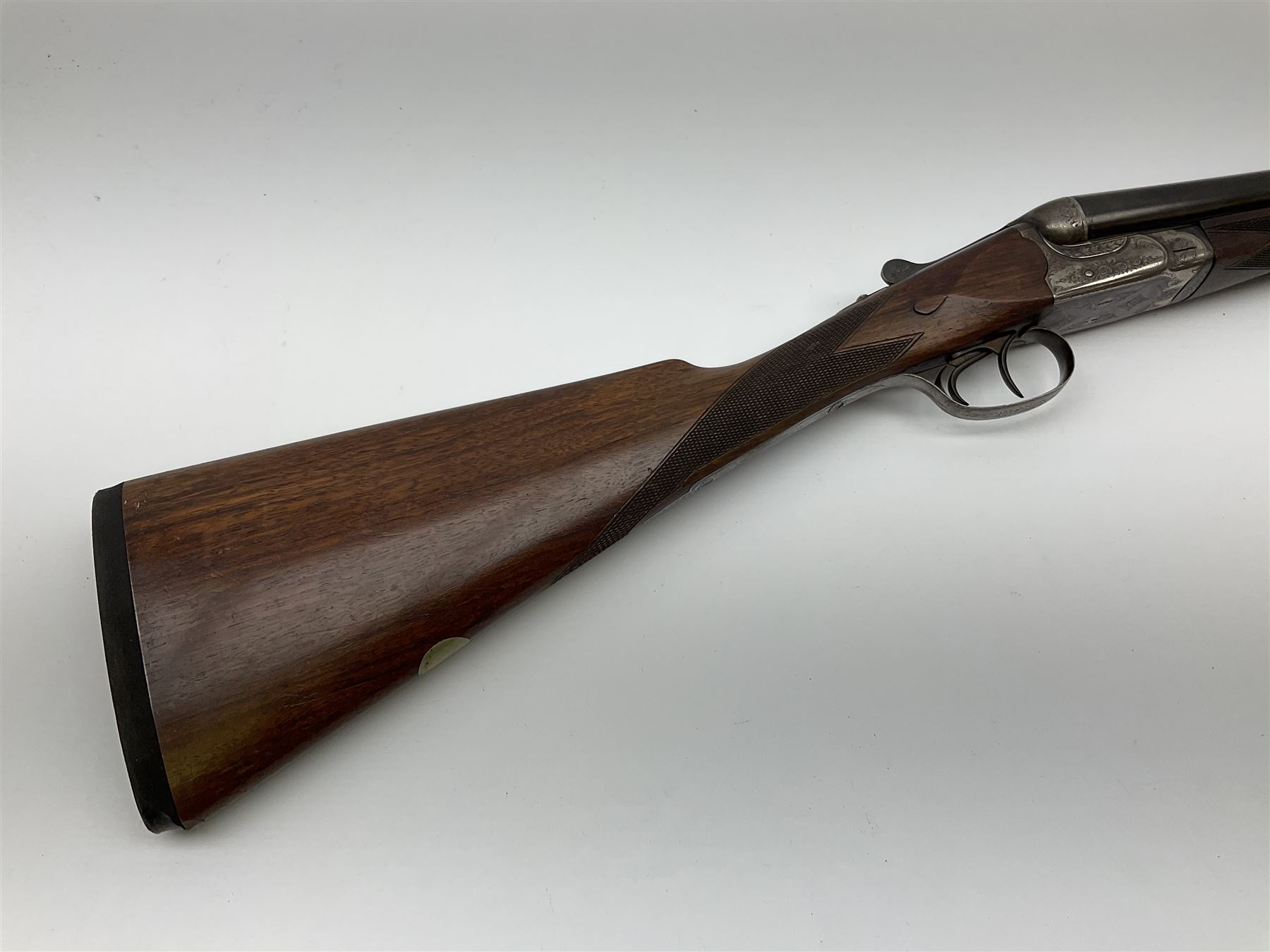 Harrods Ltd. Brompton Road London (Retailer) 12-bore side-by-side boxlock non-ejector sporting gun, 75cm barrels, walnut stock with chequered grip and fore-end and thumb safety, serial no.015, L118.5cm overall SHOTGUN CERTIFICATE REQUIRED