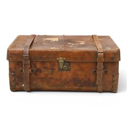 19th century leather trunk, featuring brass lock, with leather anchoring straps around the...