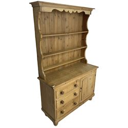 Early 20th century and later pitch pine farmhouse dresser,three-tier plate rack over three drawers and single cupboard, on turned feet