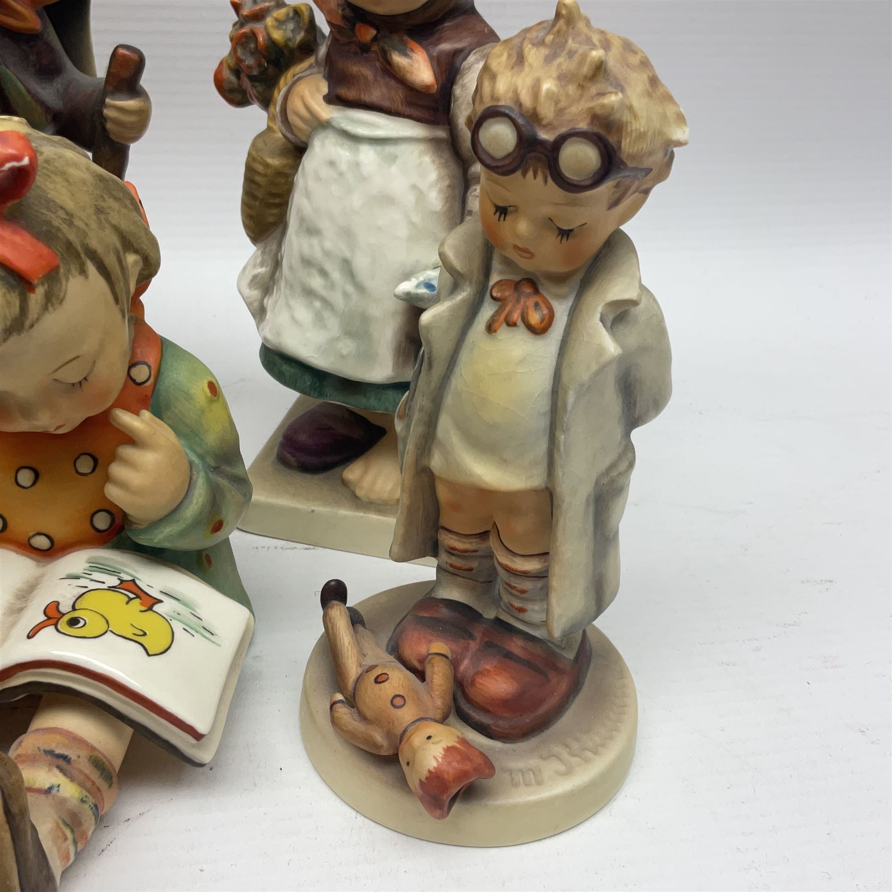 Sixteen Goebel Hummel figures, including Charlot A Young Man's Fancy, Stormy Weather and Bookworm, all with impressed and printed marks beneath